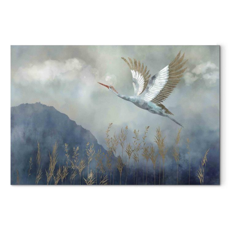Tableau sur toile A Heron in Flight - A Bird Flying Against the Background of Dark Blue Mountains Covered With Fog